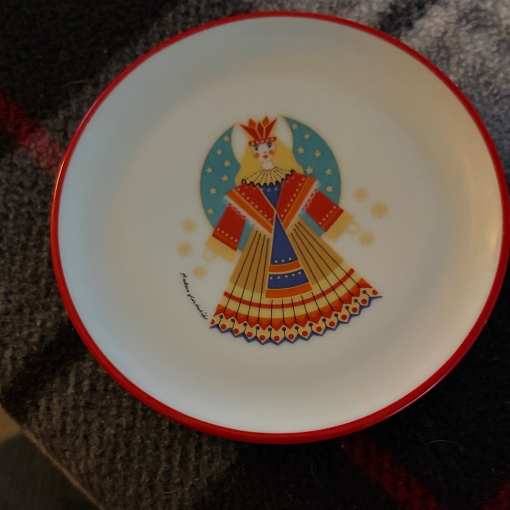 Decorative White Plate with Red Rim and Folk Art Doll Design